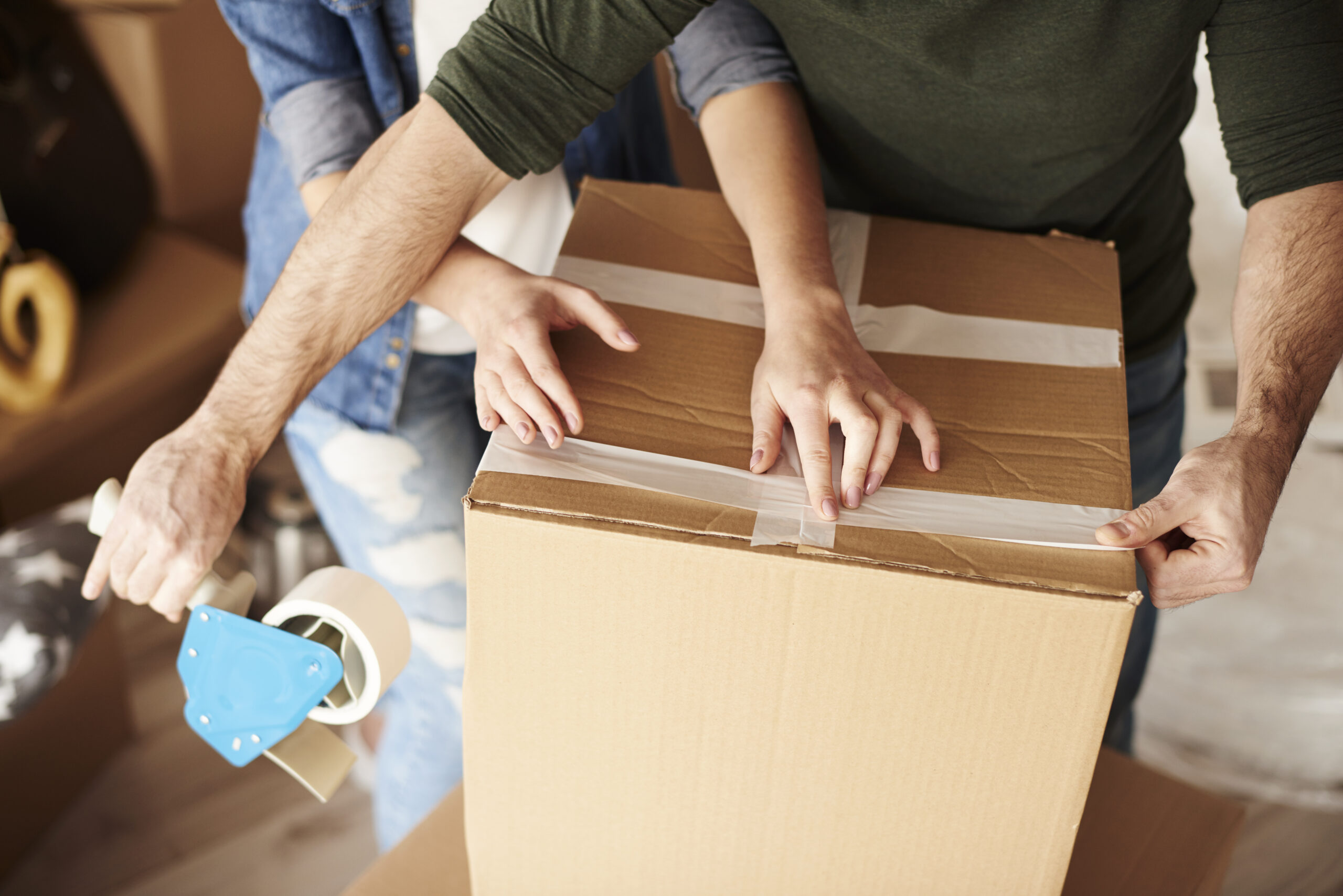young-couple-unpacking-moving-boxes-new-flat